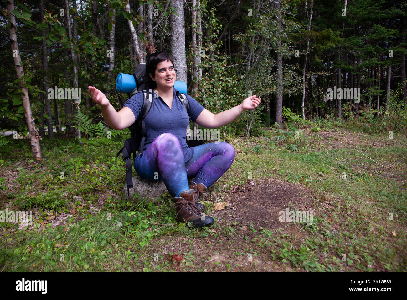 Woman sitting on rock arms hi-res stock photography and images - Alamy