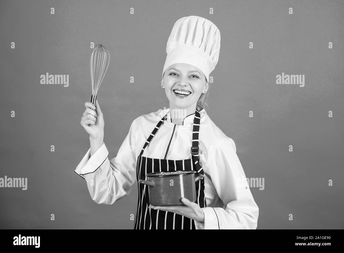 Whipping cream tips and tricks. Use hand whisk. Woman professional chef hold whisk and pot