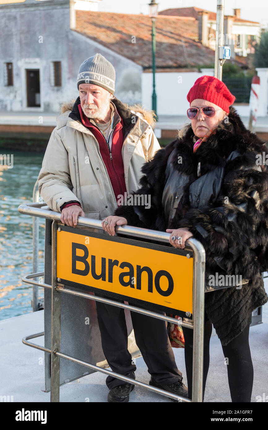 VENICE, ITALY - SEPTEMBER 01, 2014: A man and a woman are standing on the dock of the island of Burano in Venice. Italy Stock Photo