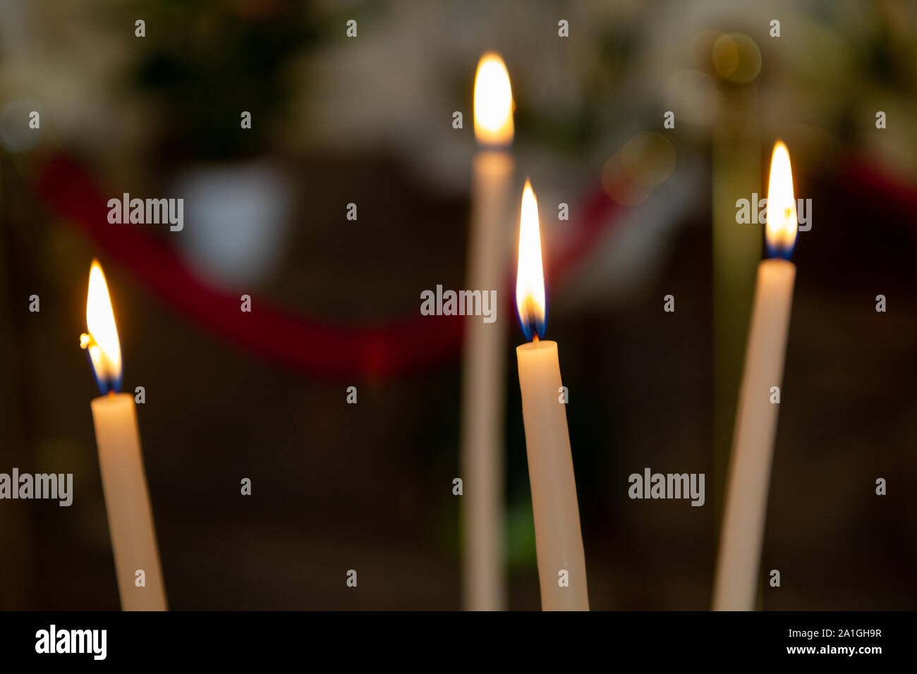 Candles burning in the Church of Notre-Dame-de-Lorette in Ablain-Saint-Nazaire, France. - Stock Image