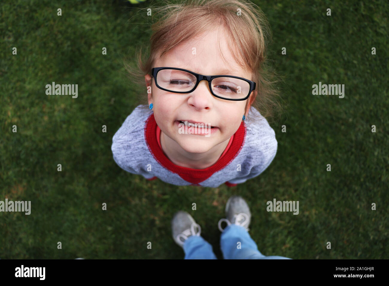 Child looking up with a silly facial expression Stock Photo