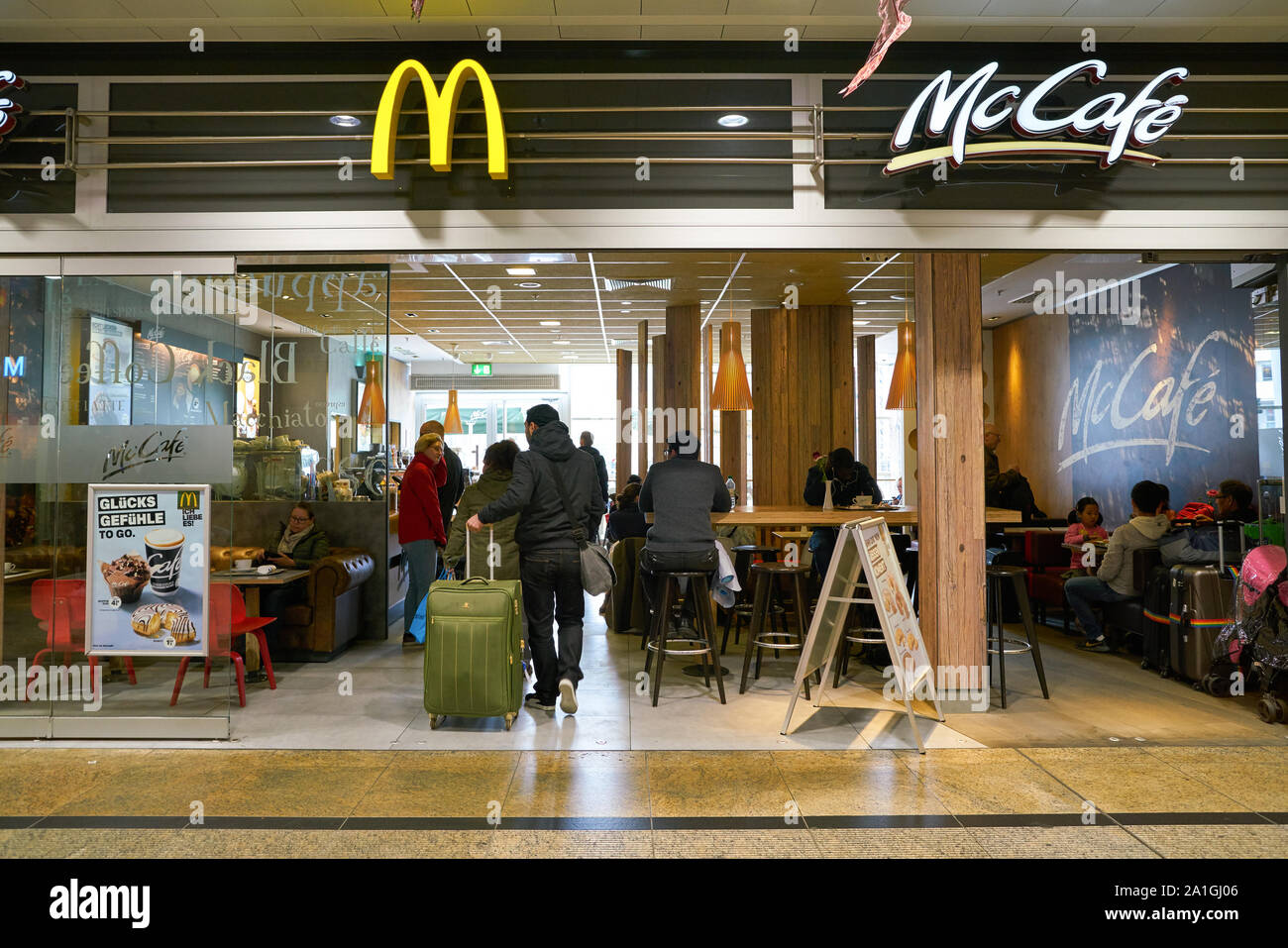 COLOGNE, GERMANY - CIRCA OCTOBER, 2018: Golden Arches and McCafe sign over McDonald's restaurant entrance in Cologne. Stock Photo