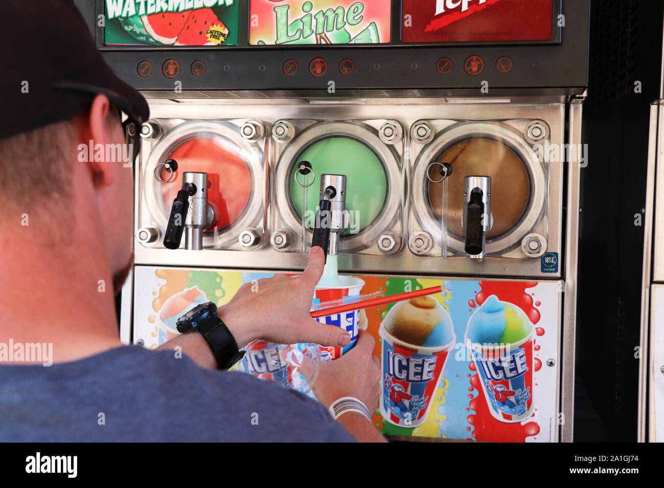Man self-serving a cup of ICEE Stock Photo