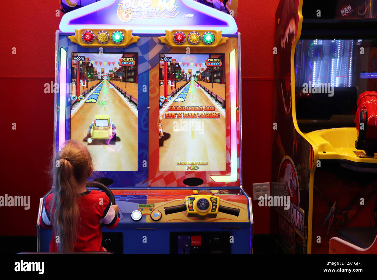 Child playing a video game at the arcade Stock Photo