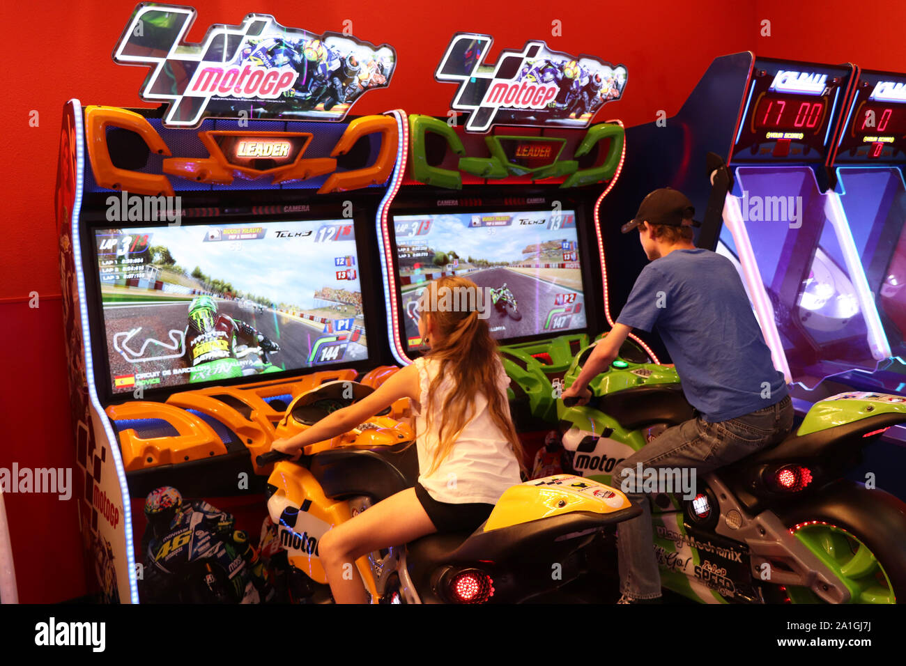 Two playing a video game at the arcade Stock Photo