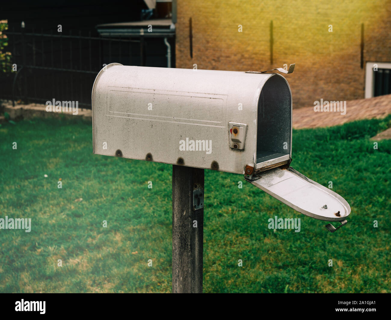 Side view of traditional american style open mailbox in front of the
