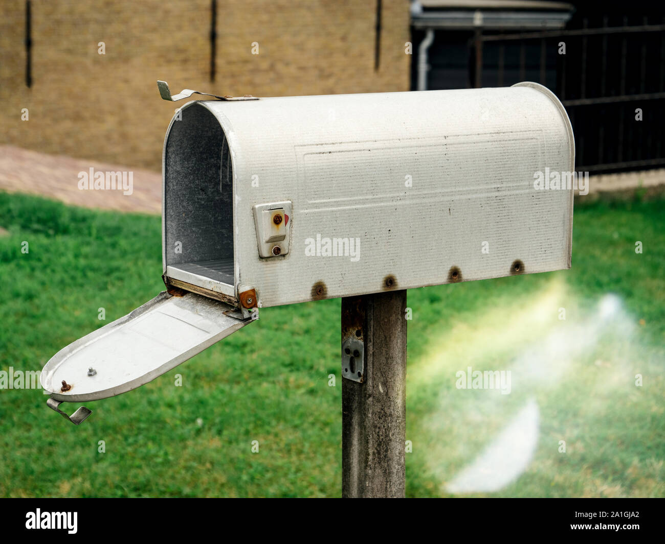 American style open mailbox in front of the house with no letters or