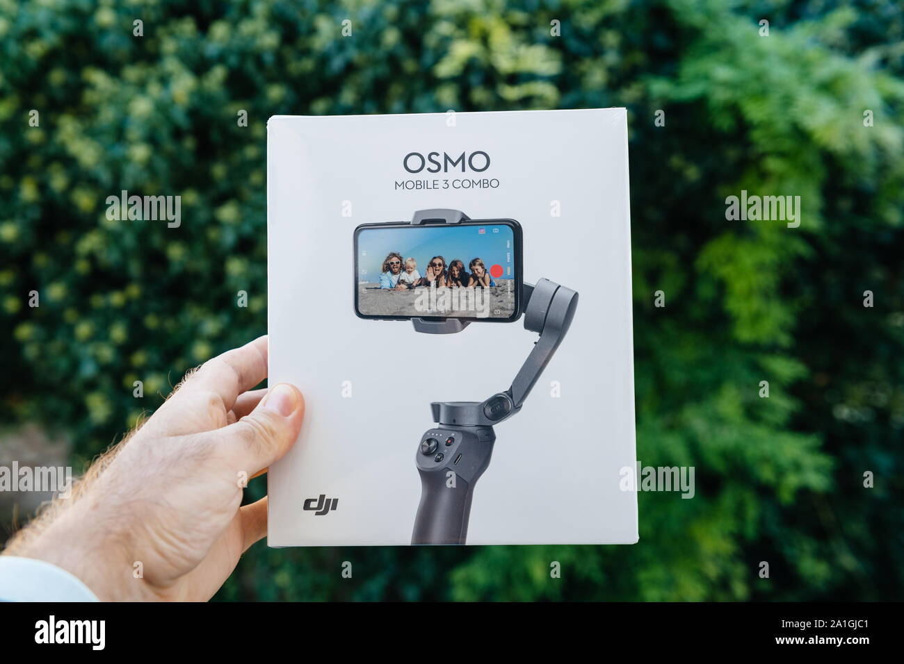 Paris, France - Spe 12, 2019: Man hand holding against green background new  cardboard packaging box of DJI Osmo Mobile 3 combo smartphone folding  gimbal for cinematic and photo experiences front packaging Stock Photo -  Alamy