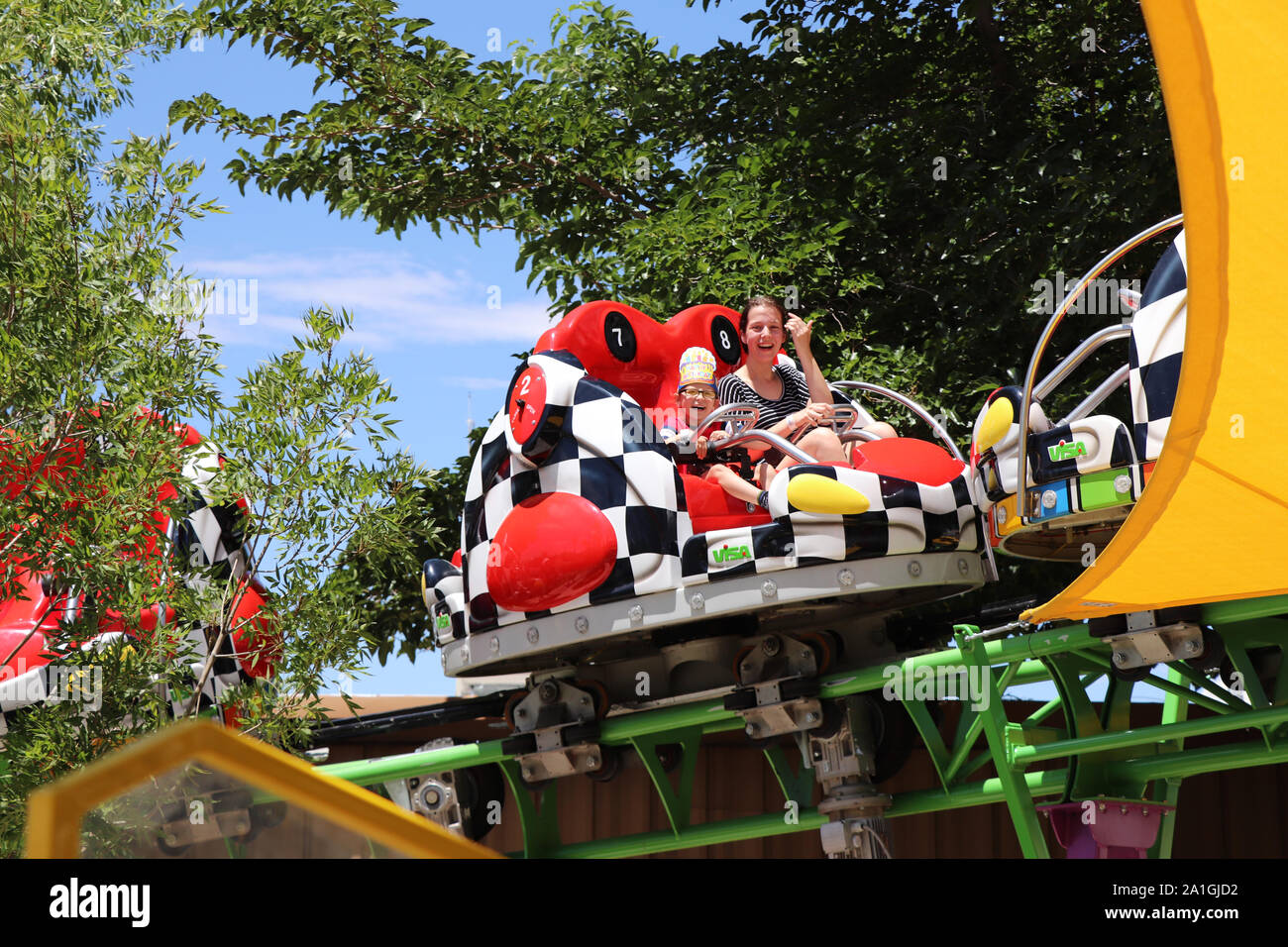 Someone On Ride People taking a ride at the theme park Stock Photo - Alamy