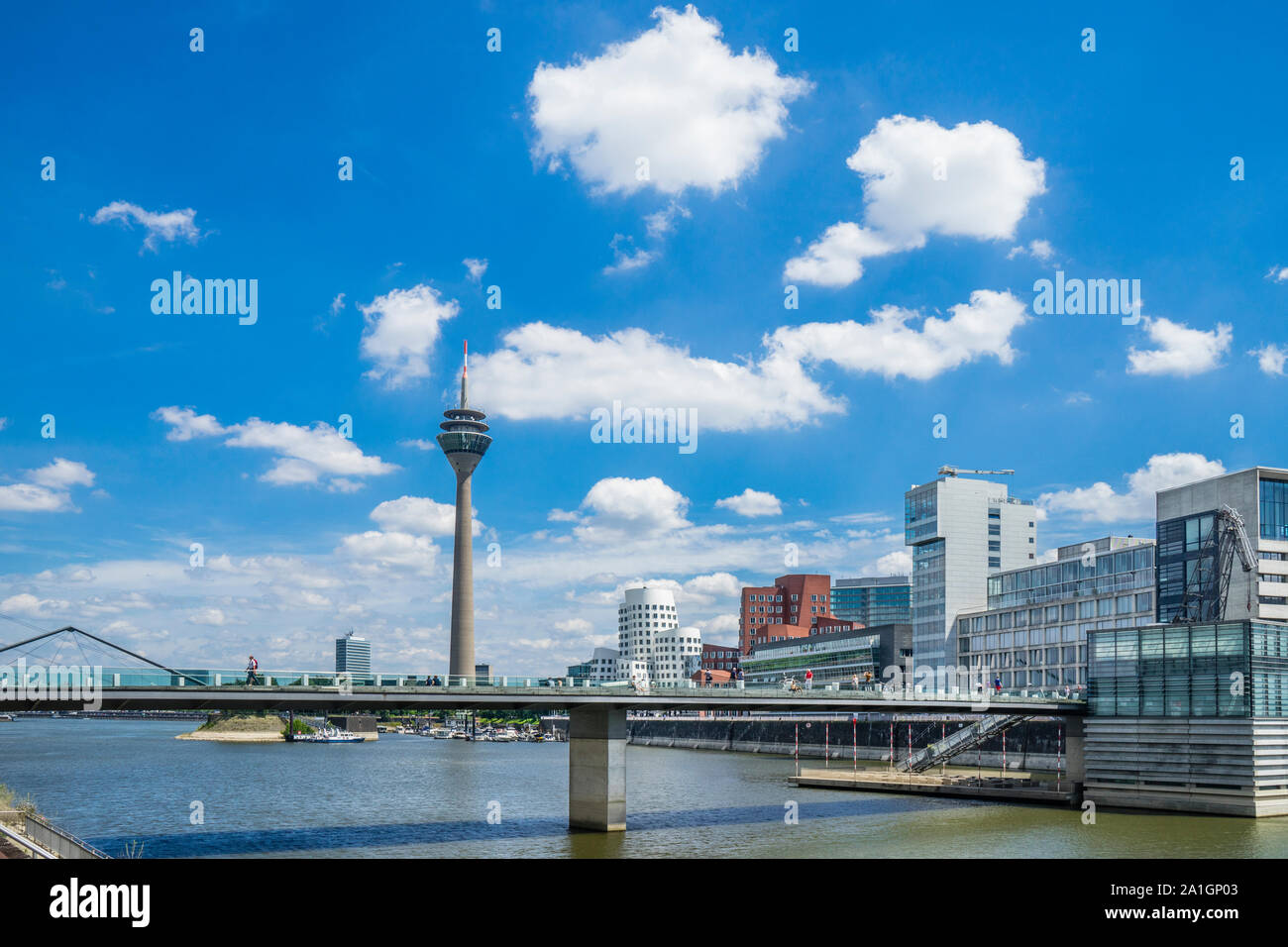 Media Harbour Düsseldorf with view of the Neuer Zollhof buildings and its postmodern architecture of the Gerry buildings, the pedestrian bridge and th Stock Photo