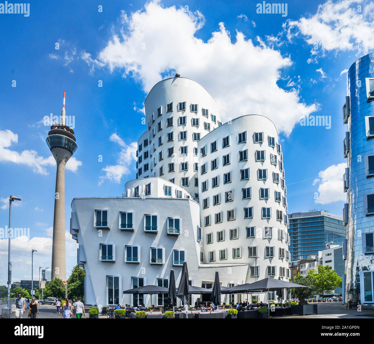The Rheinturm tower and Neuer Zollhof Gerry Buildings at Düsseldorf Media Harbour spiraling and stretching into the sky in american architect Frank O. Stock Photo