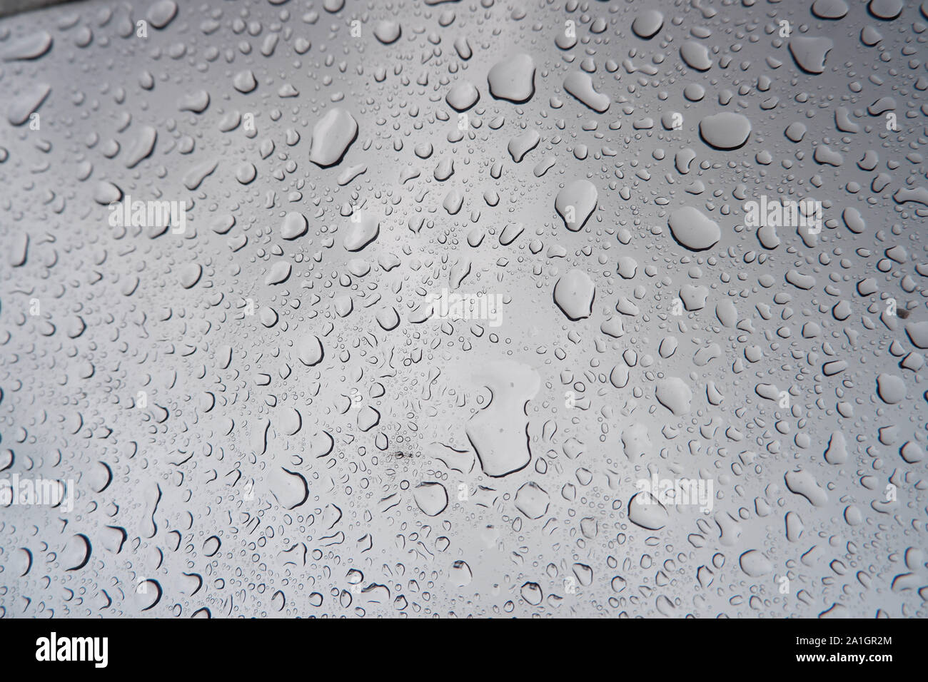 Water droplets stick on the glass surface. Stock Photo