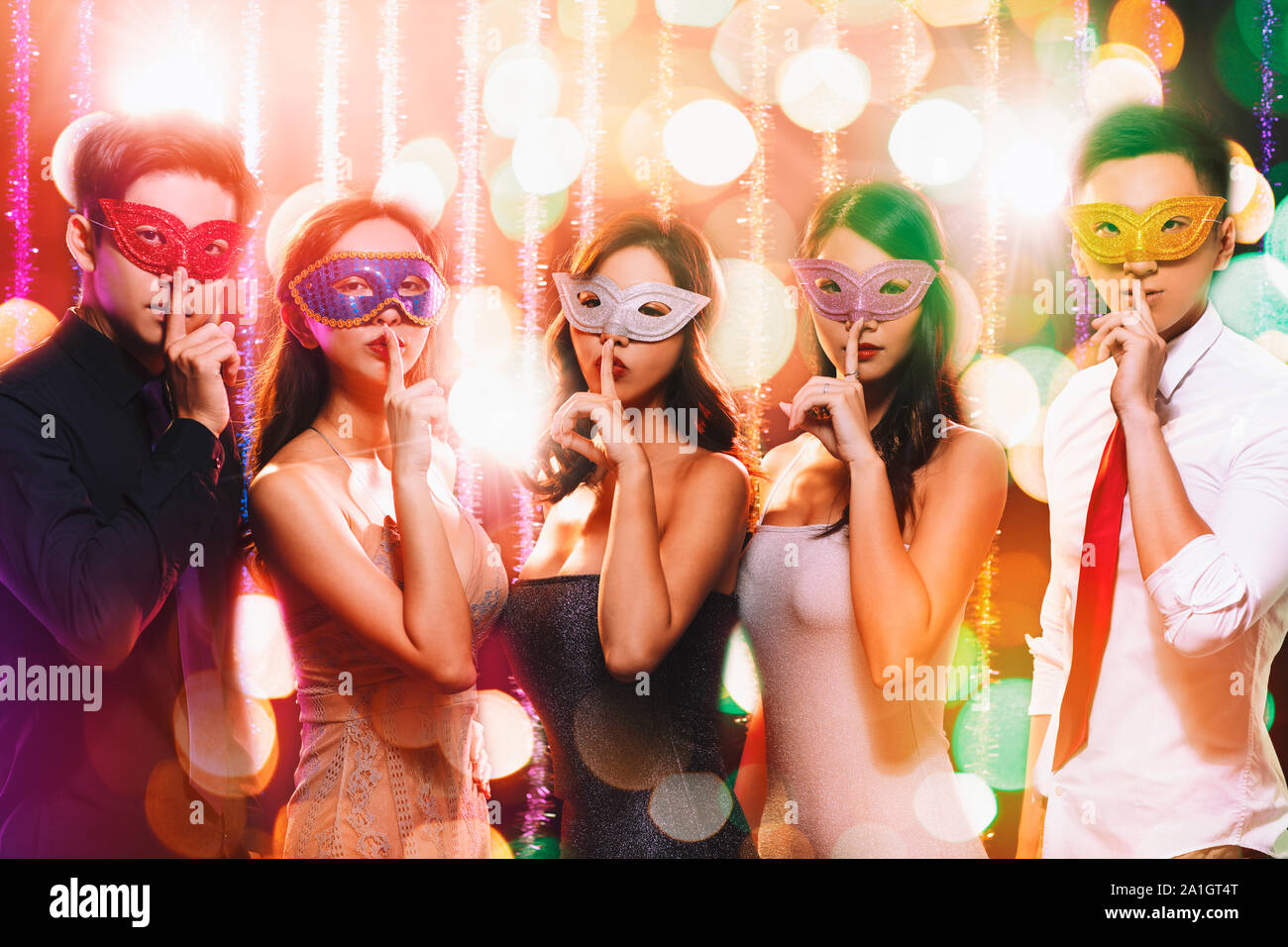 young group celebrating New Year on masquerade party Stock Photo