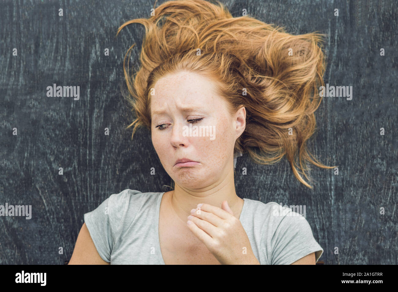 The young woman has emotions of disgust. Stock Photo