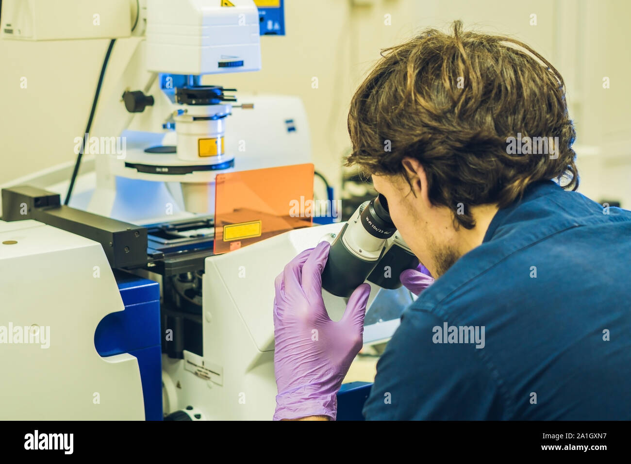 Scientist work on a confocal scanning microscope in a laboratory for biological samples investigation. Stock Photo