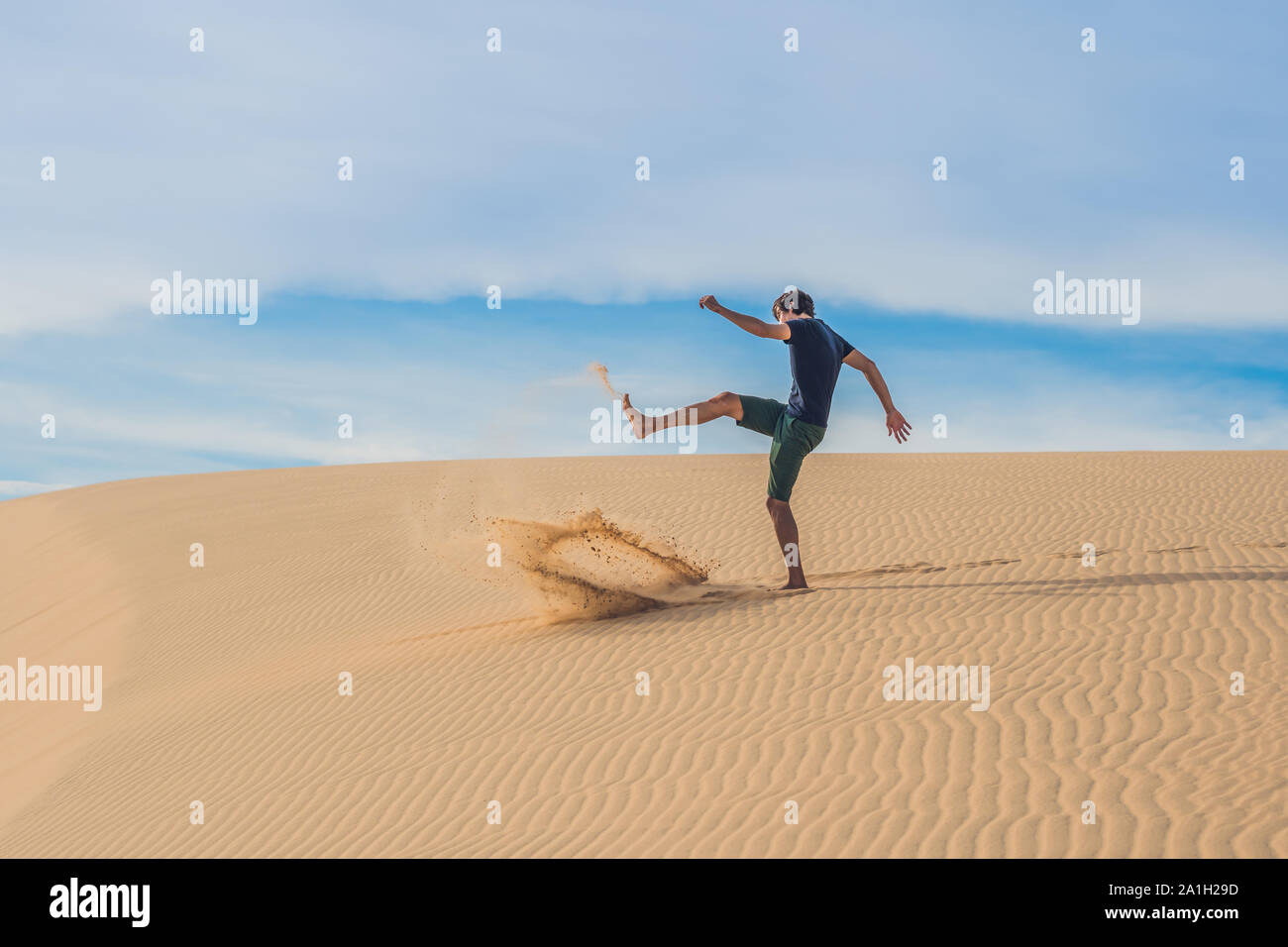 Man kicks the sand, annoyance, aggression Desert Vietnam Stock Photo ...