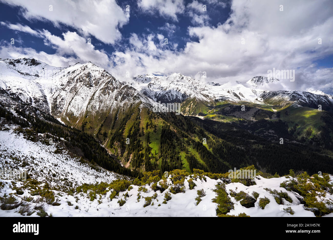 Landscape of snow mountain valley against cloudy sky in Kazakhstan Stock Photo