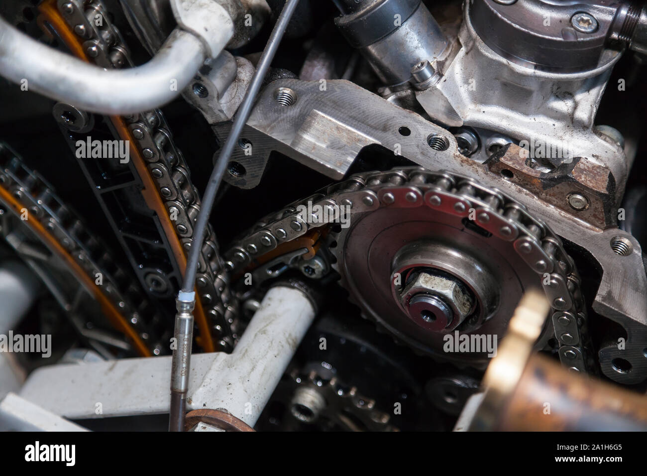 Closeup on a disassembled engine with a view of the gas distribution mechanism, chain, gears