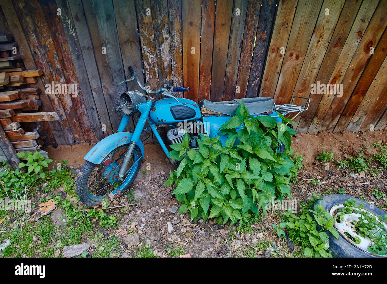 An old abandoned motorcycle stand near a fence Stock Photo - Alamy