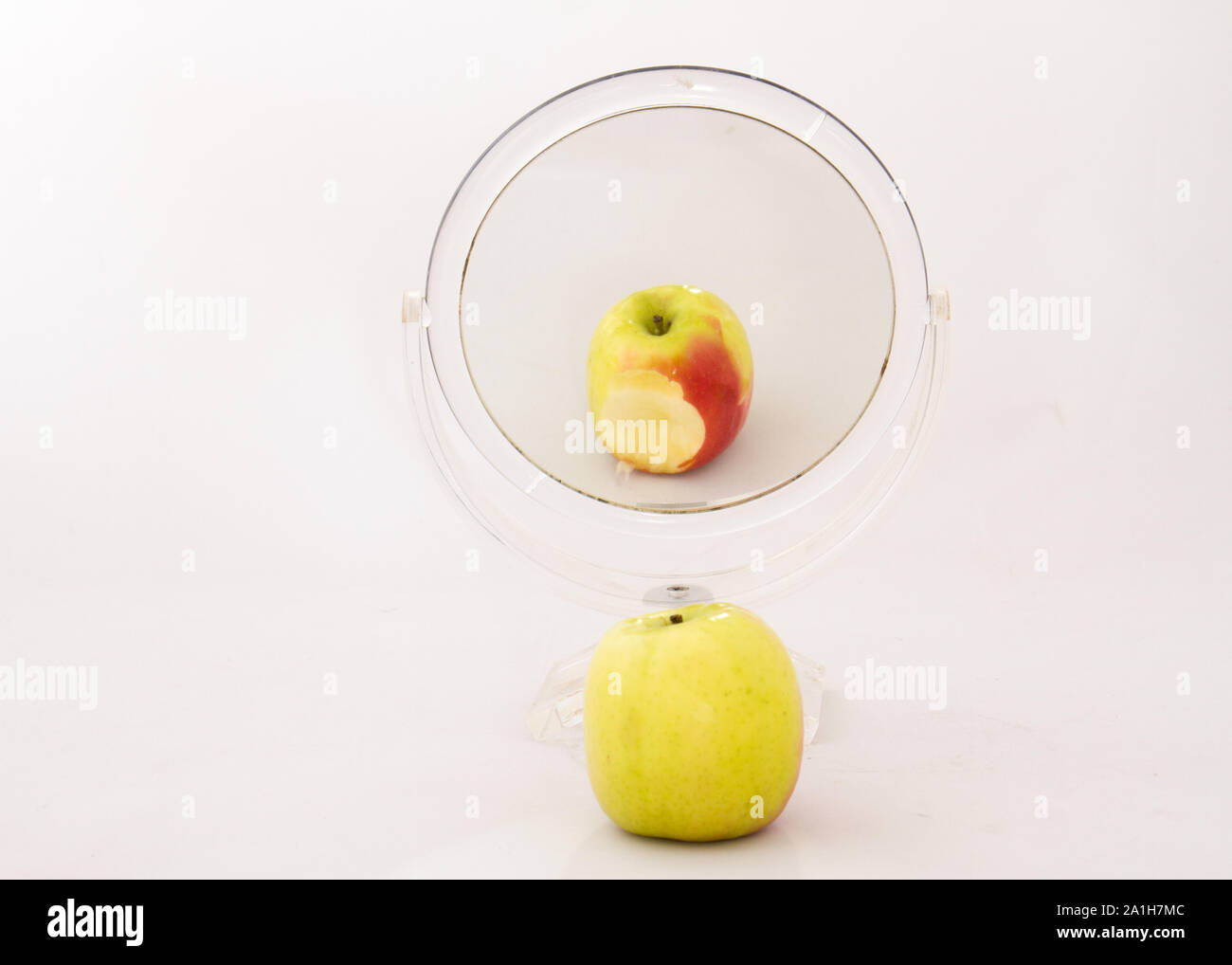 A Half Eaten Apple Reflected In A Small Mirror Concept Vanity Isolated