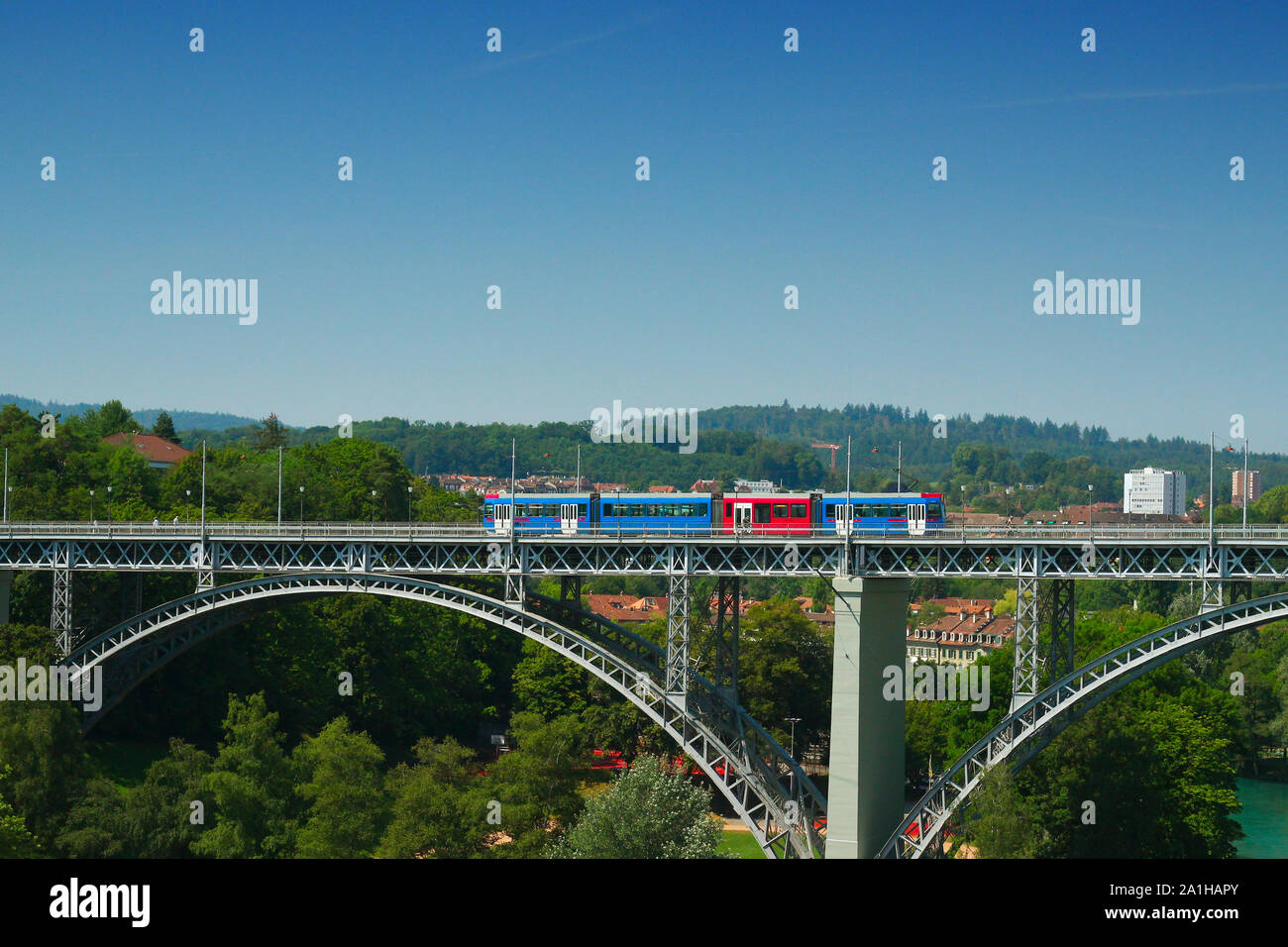 A tram runs over the bridge 'Kirchenfeldbrucke' in Bern, Switzerland on a summer day in 2019 Stock Photo