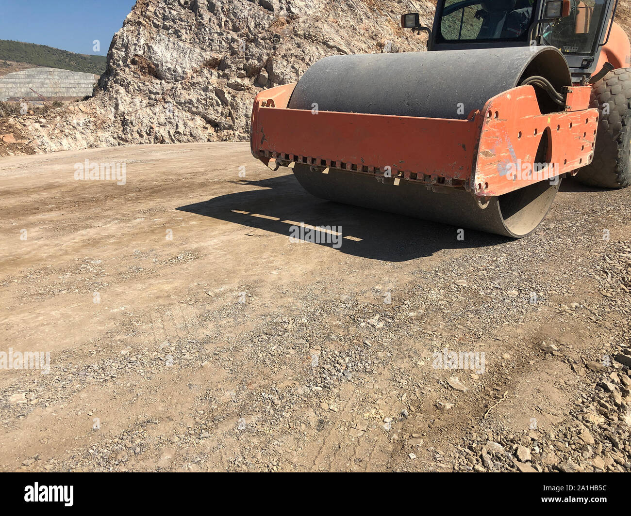 Vibrating roller compresses the soil of a road surface during road  construction works. Earthmoving, excavations, digging on the rocky soils  Stock Photo - Alamy