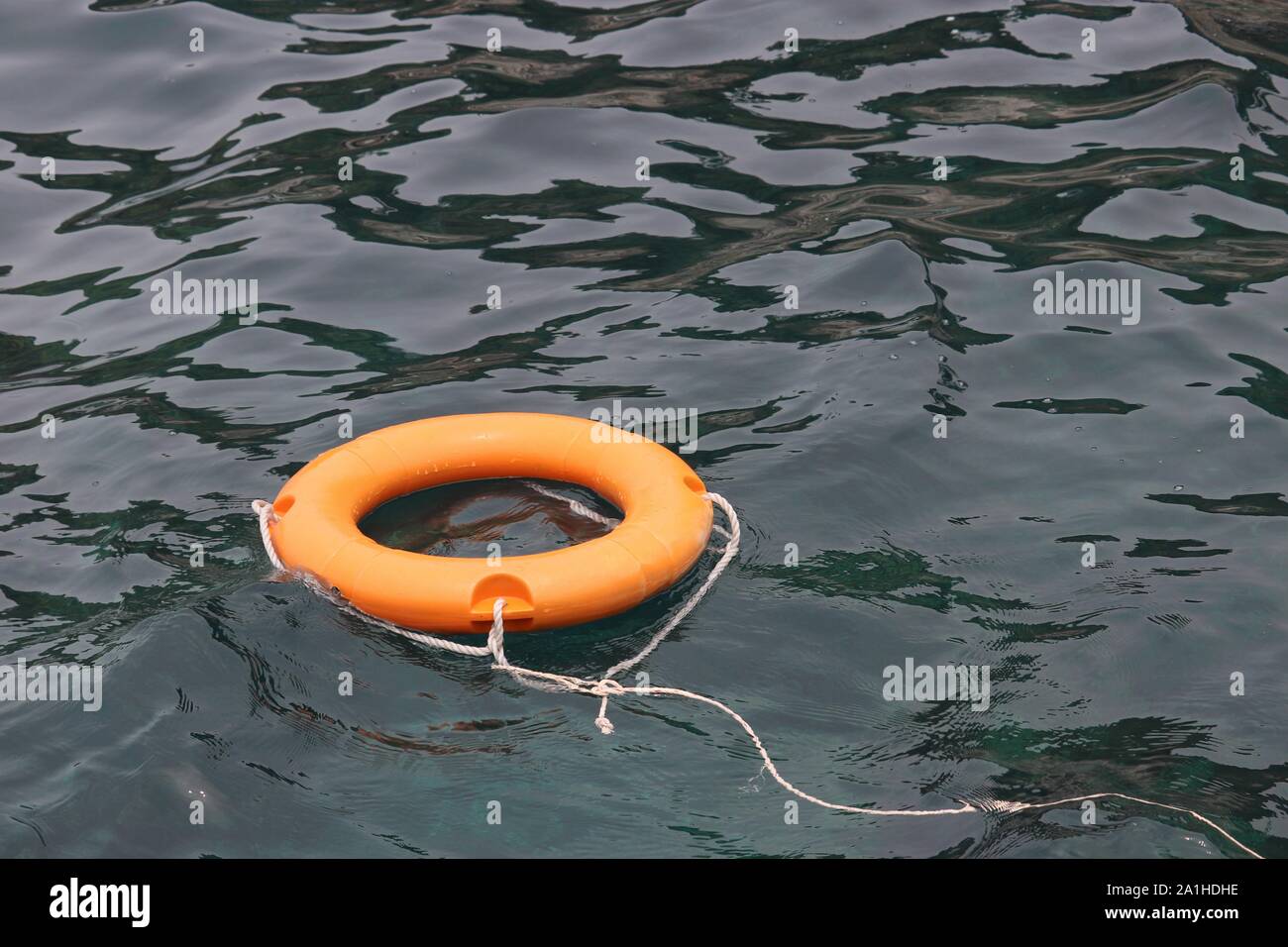 Orange life ring at sea, safety on the water. Lifebuoy on the beach, concept of saving a drowning Stock Photo