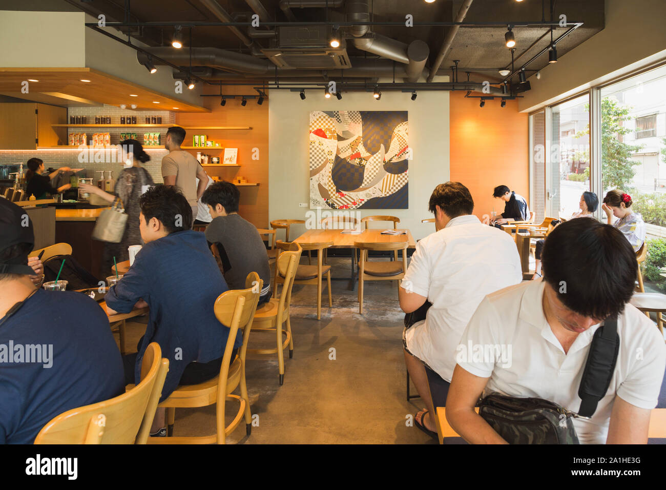 The Japanese style wall art piece is highlighted as a focal point at the Starbucks Coffee Asakusa shop in Tokyo, Japan. Stock Photo