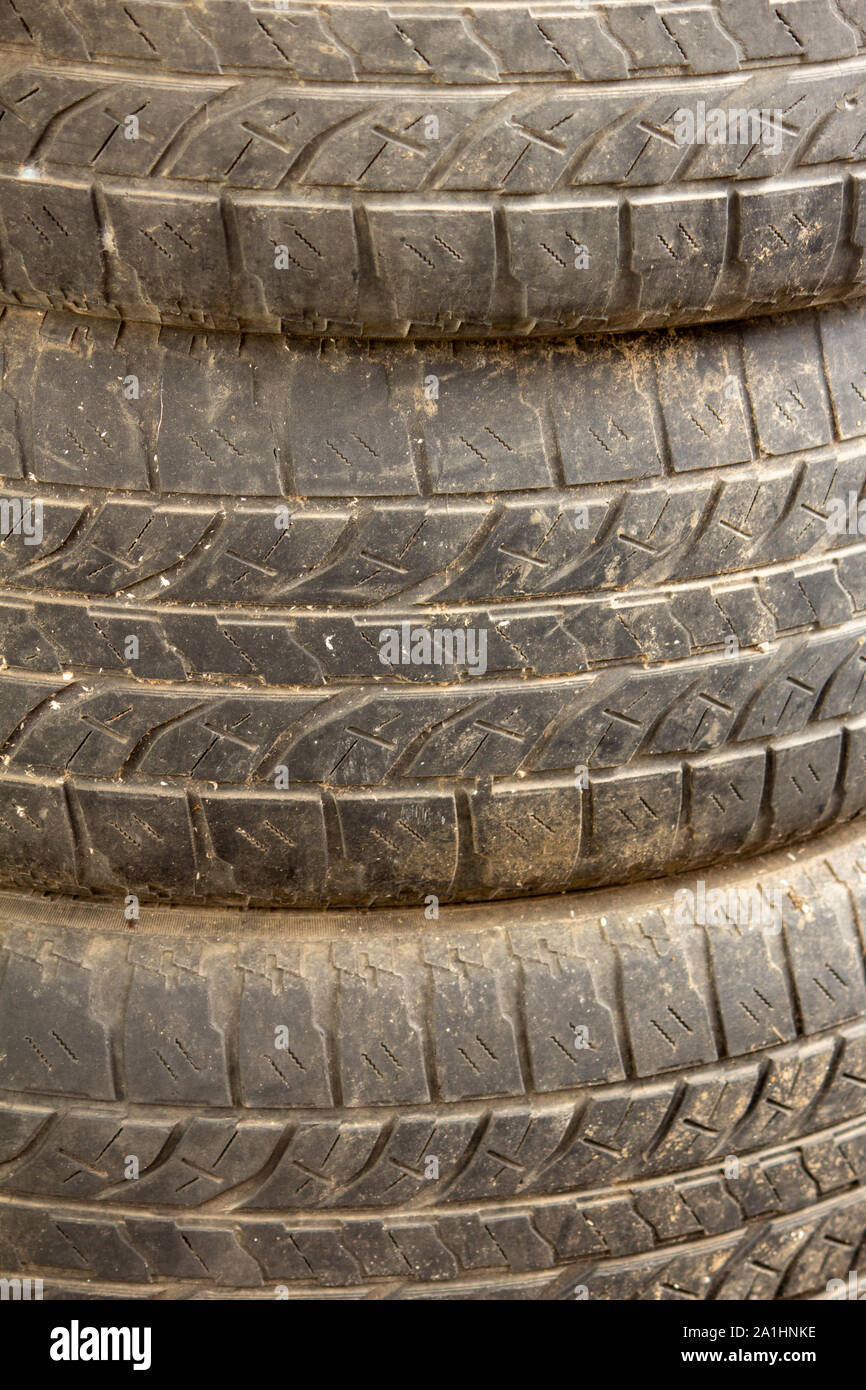 View of old tyres stacked over one another. Stock Photo