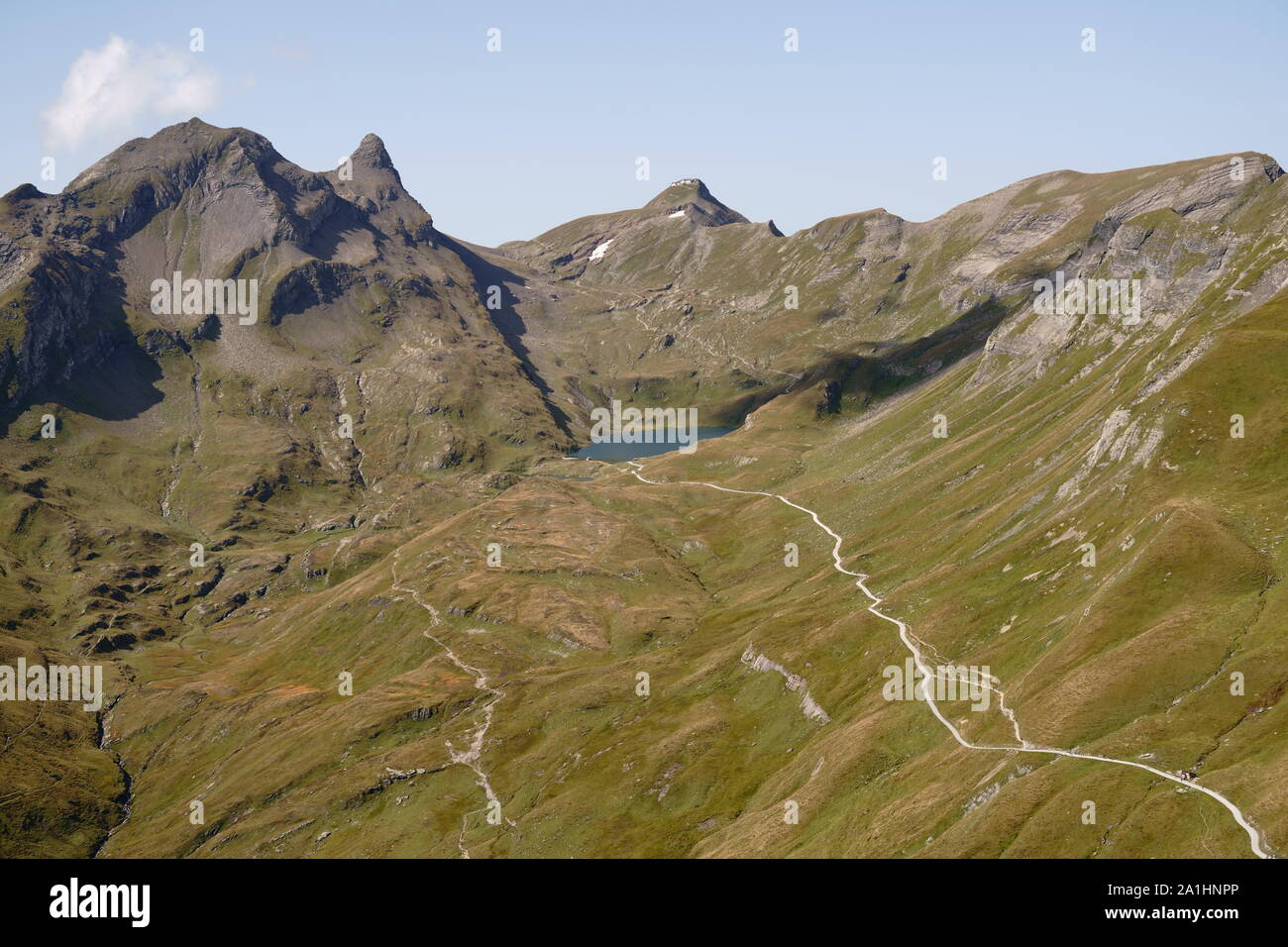 Hiking trail leading to lake Bachalpsee above Grindelwald in the Bernese Alps, Switzerland. Late summer aerial landscape panorama. Stock Photo