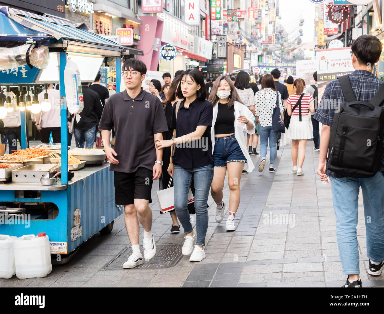 Suwon, South Korea - June 15, 2017: Young korean couple walking along the main street in Suwon. Stock Photo