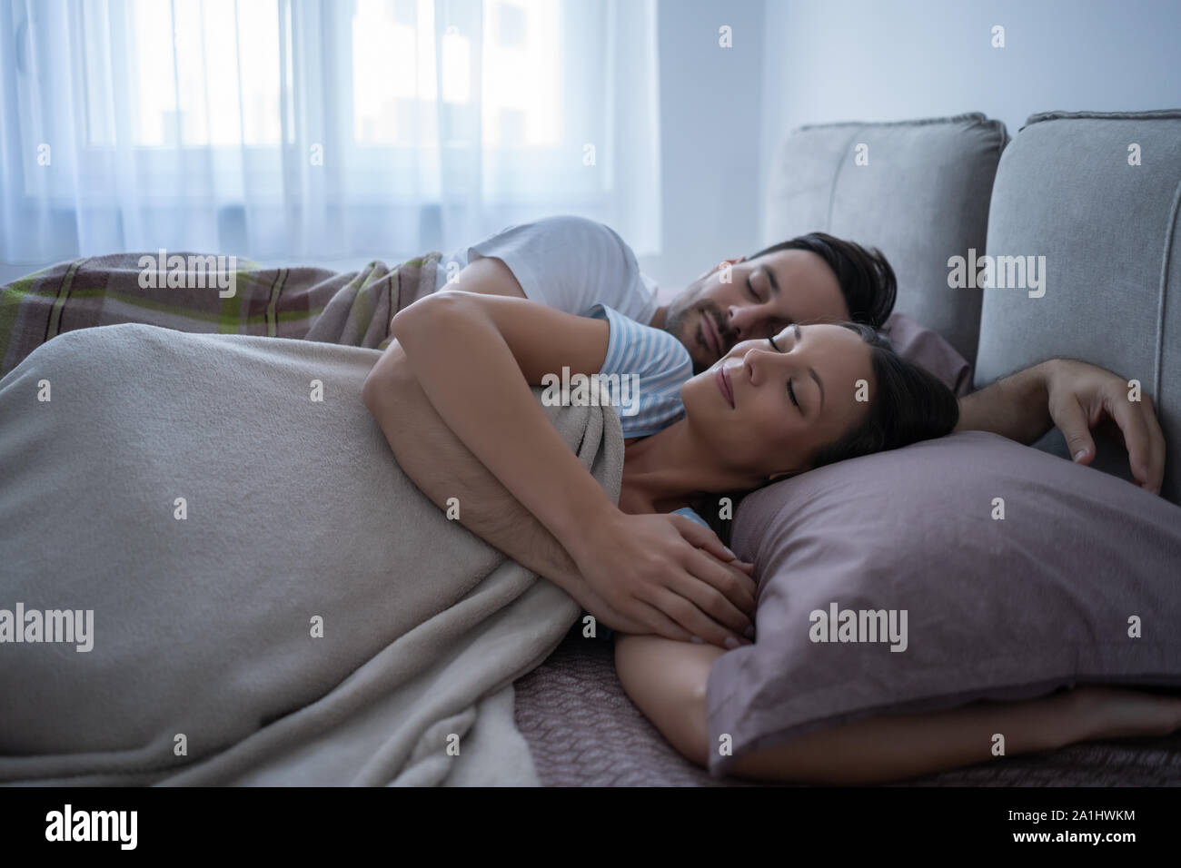 Young couple is lying in bed and sleeping. Stock Photo