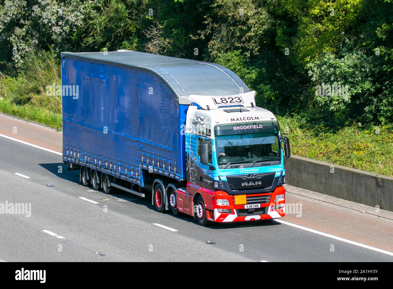 L823 Malcom (Brookfield) providing Logistics, Rail, Construction and Maintenance solutions; Heavy bulk Haulage delivery trucks, haulage, lorry, transportation, truck, cargo, MAN  vehicle, delivery, transport, industry, supply chain freight, on the M6 at Lancaster, UK Stock Photo