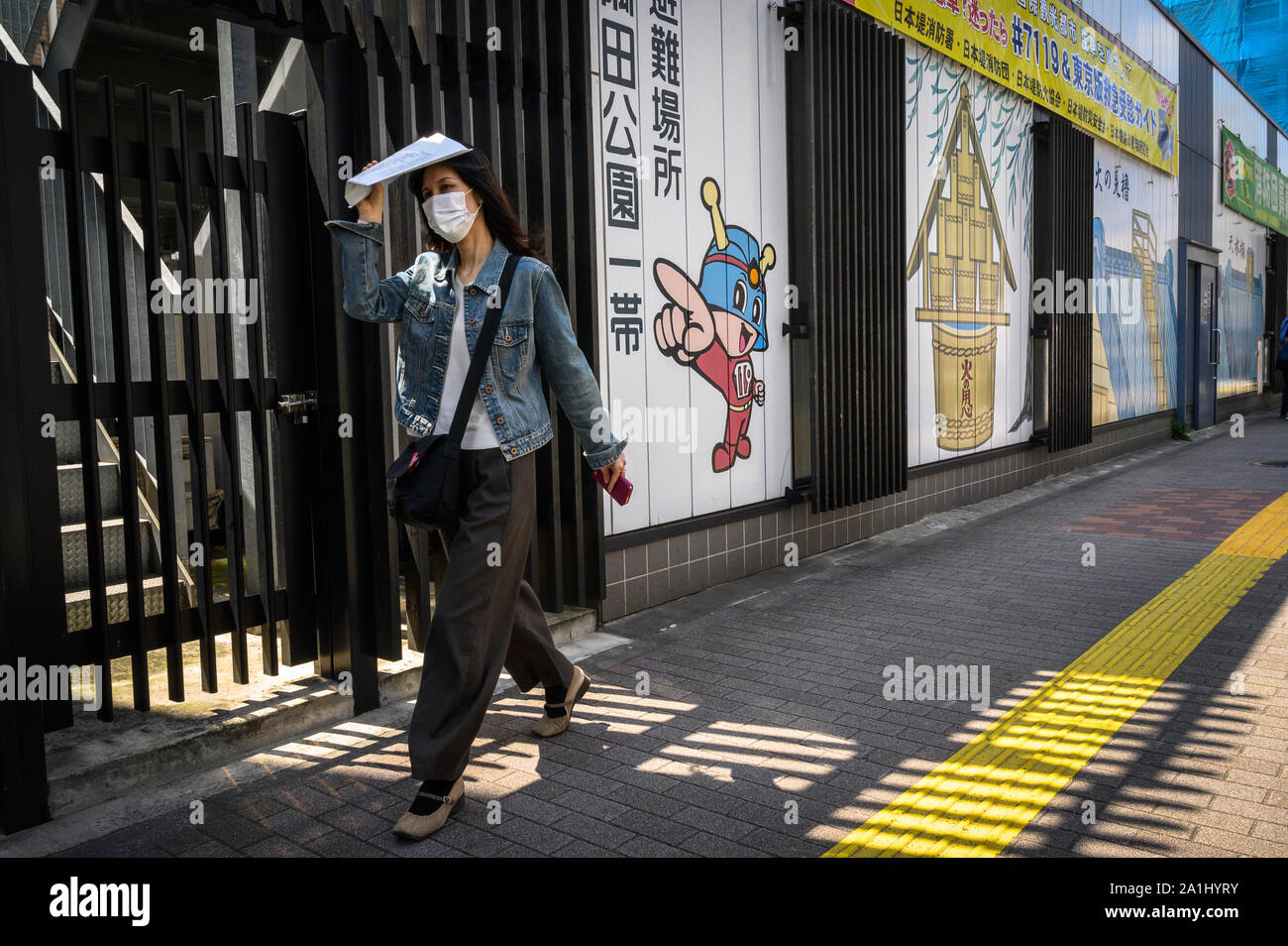 Woman walking down the street in Asakusa, Tokyo, Japan Stock Photo