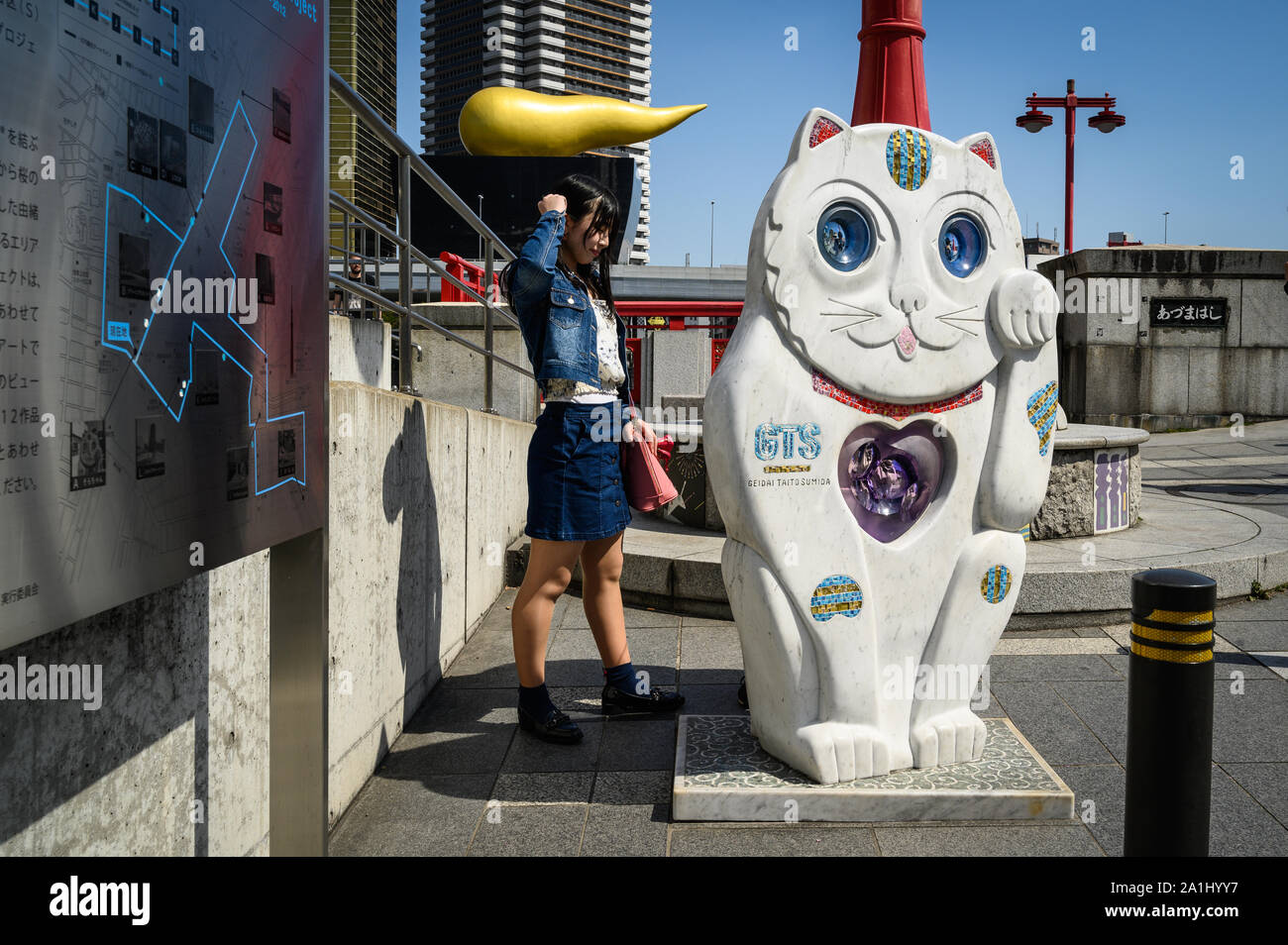 Tourist near Ueno Station with the Asahi Flame in the background, Tokyo, Japan Stock Photo