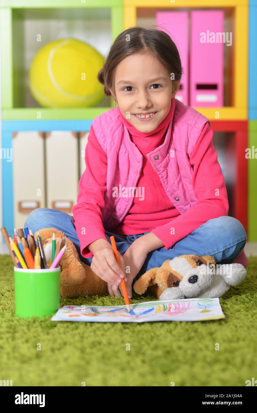 Portrait of cute little girl sitting on floor Stock Photo - Alamy