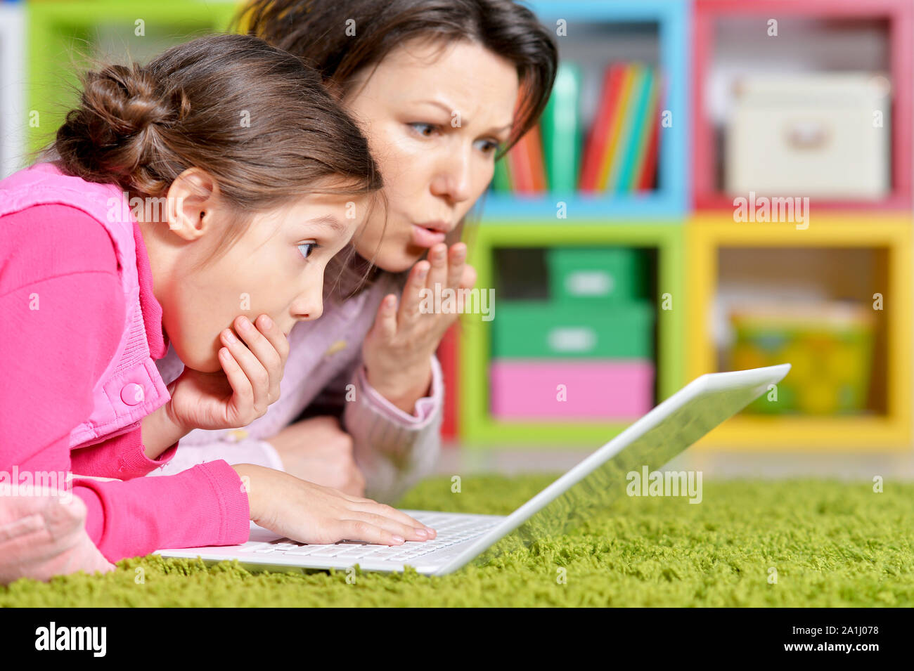 happy mother and daughter using laptop together Stock Photo - Alamy