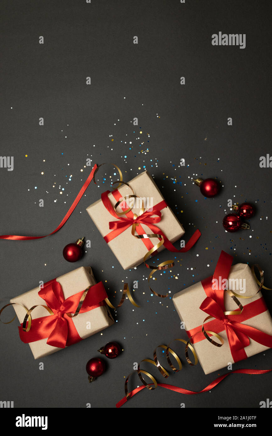 Christmas background with gift boxes with red bow on dark background ...