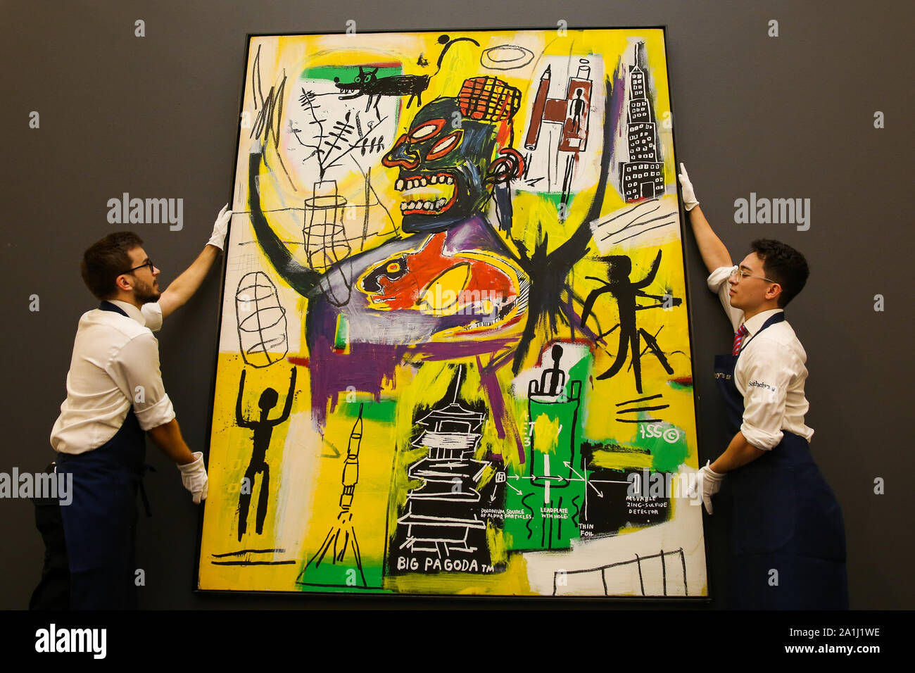 London Sotheby's, London, UK. 27 Sept 2019 - Technicians hold Jean-Michel  Basquiat's artwork titled "Pyro" during the preview of SothebyÕs Frieze  Week Contemporary Art Sale. The auction will take place on 3rd