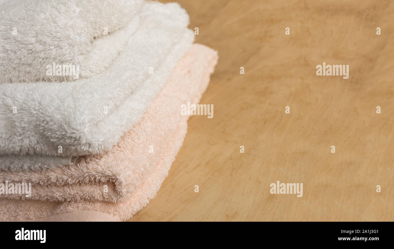 Soft bath towel on wooden background. Copy space. Mockup for design. Stock Photo