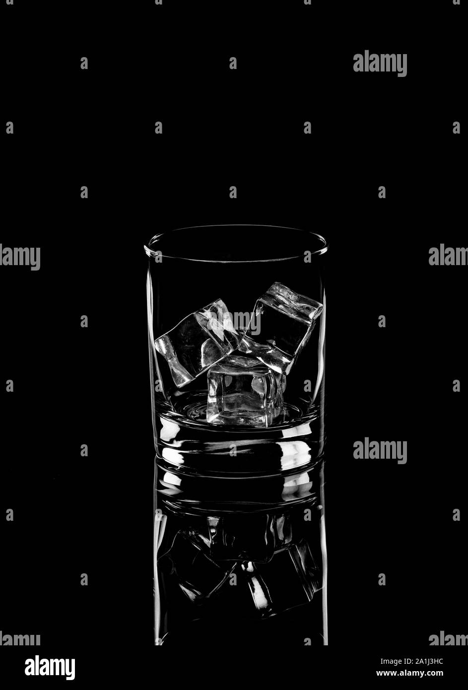 Vodka or gin tonic with ice in rocks glass on black background
