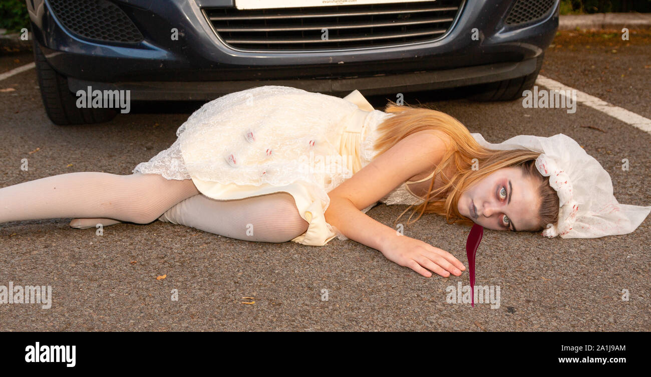 Young biride  lies covered in blood following car accident Stock Photo