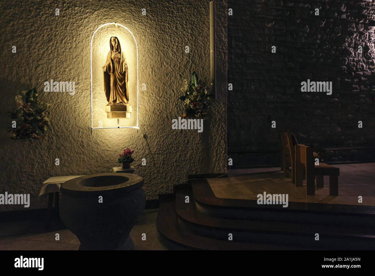 La Clusaz (eastern France). 2019/01/16: Statue of the Virgin illuminated in a niche in the church of the village Stock Photo