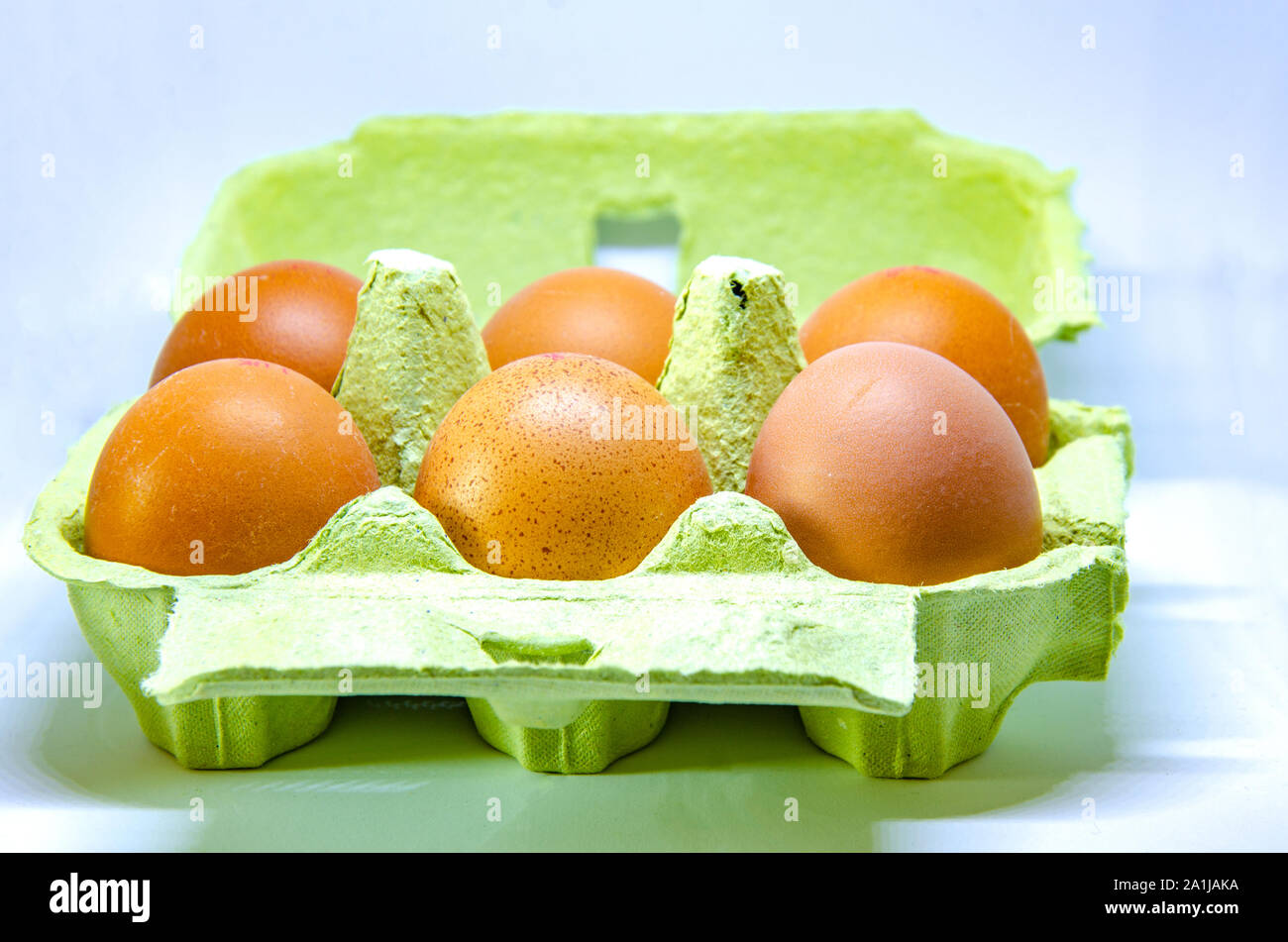 Half a dozen eggs in a paper egg box. Stock Photo