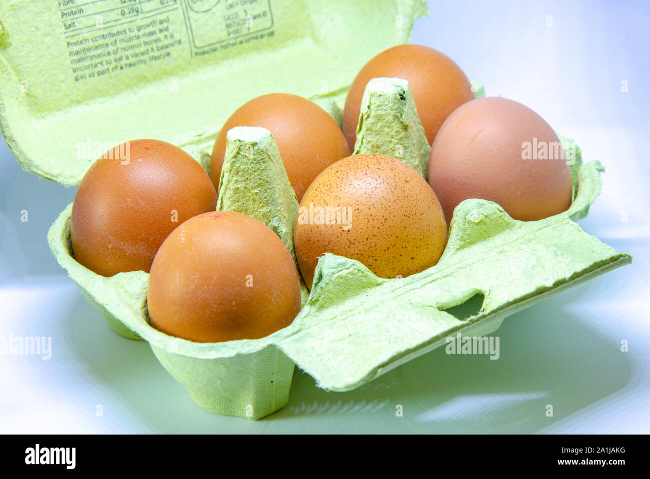 Half a dozen eggs in a paper egg box. Stock Photo