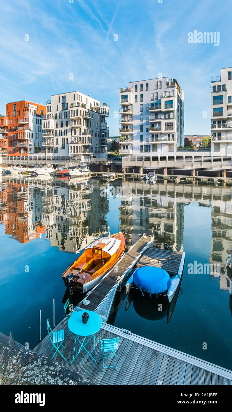 pleasure boats at mooring in westhafen quarter, residential buildings in background Stock Photo