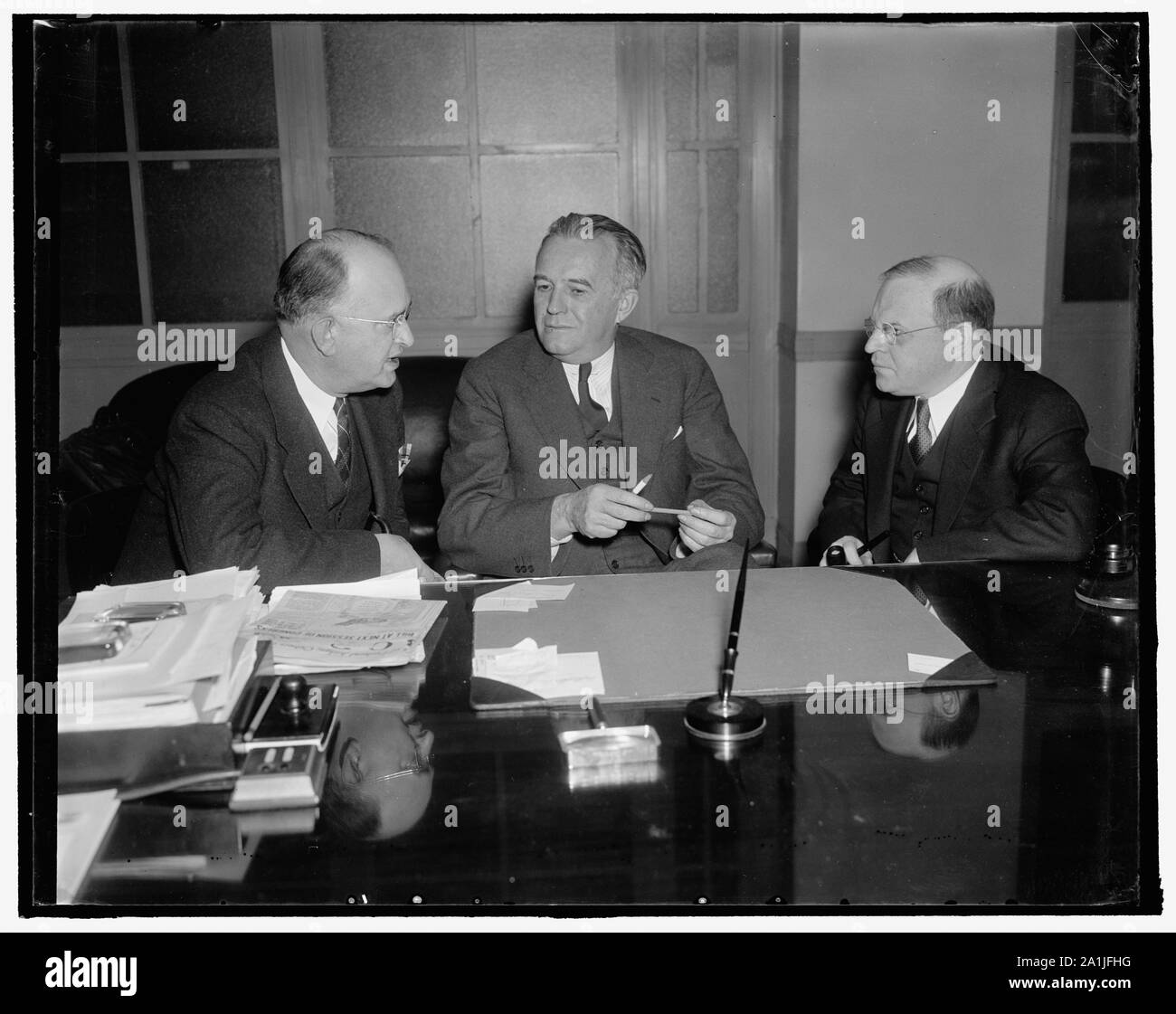 National Mediation Board. Washington, D.C., Jan. 10. A new photograph of the National Mediation Board whose members are responsible for administrating the Railway Labor Act left to right they are: George A. Cook, Secretary; O.S. Beyer; and William M. Leiserson, member, 1/10/38 Stock Photo