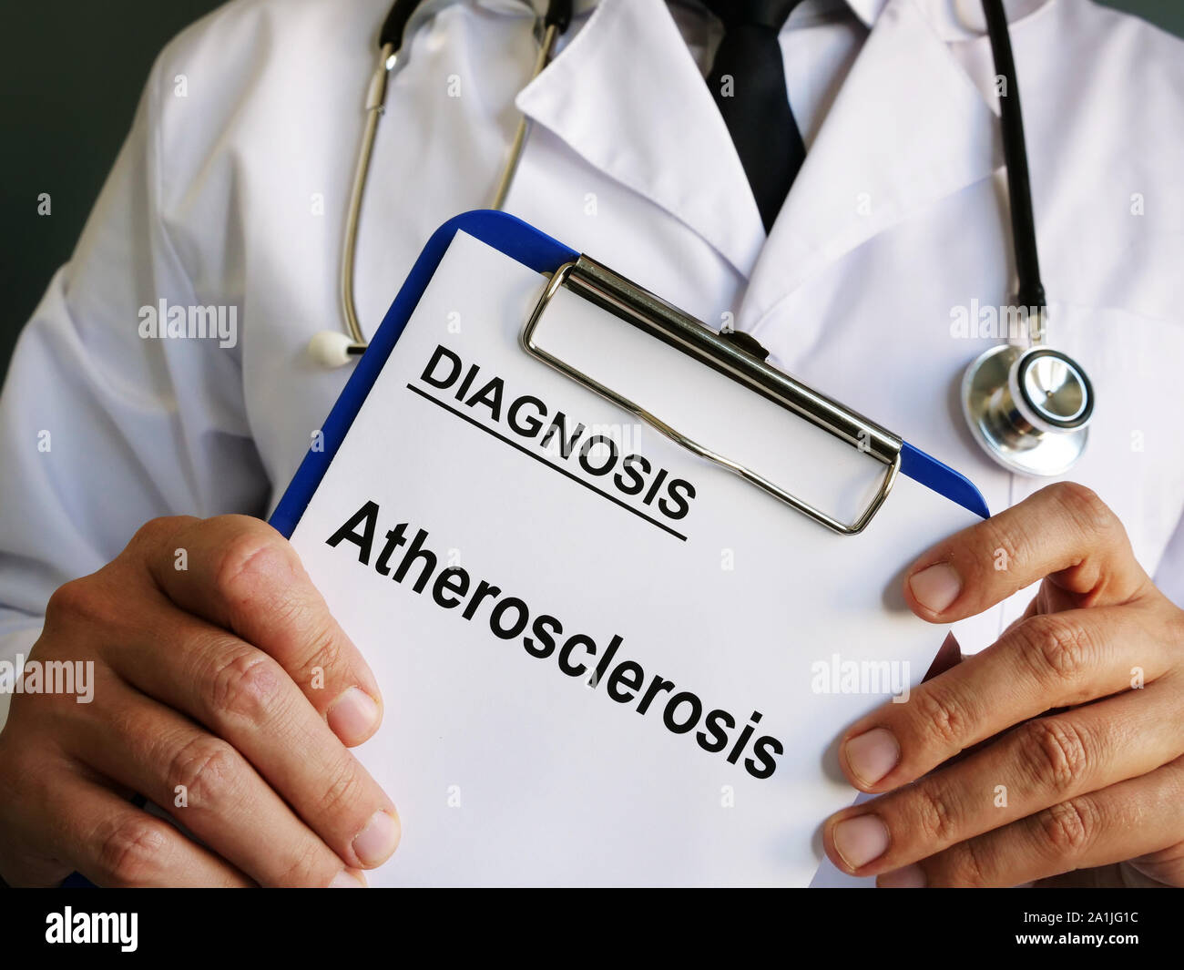 Doctor holds diagnosis Atherosclerosis on medical form. Stock Photo
