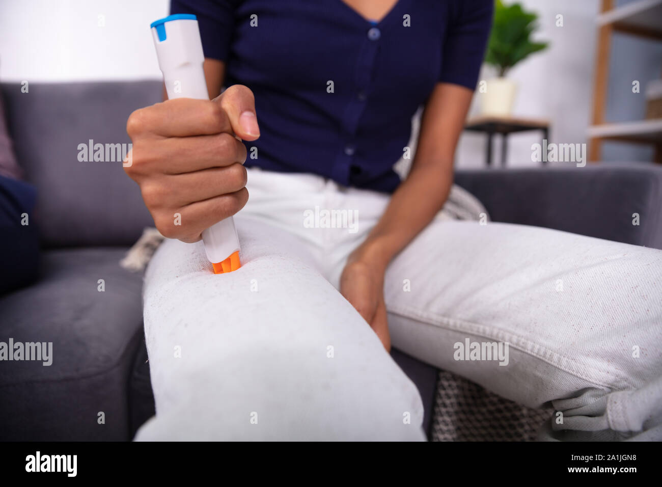 Woman Injecting Epinephrine Using Auto-injector Syringe As An Emergency Treatment For Allergic Reaction Stock Photo