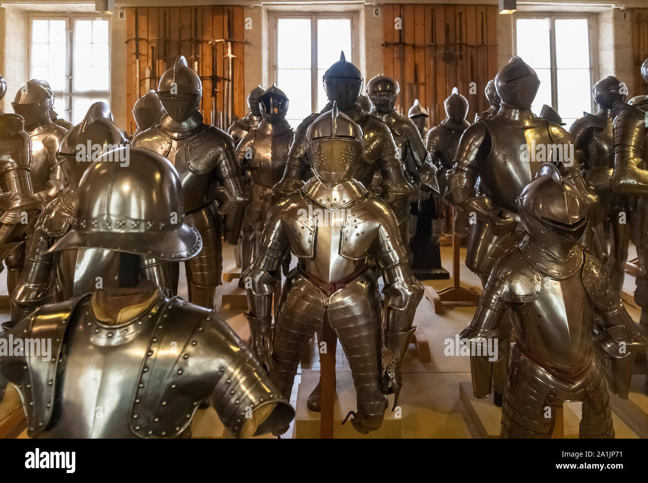 A room full of knight's armors with helmets displayed in the Département Ancien of the Musée de l’Armée which is in the famous Hôtel des Invalides... Stock Photo